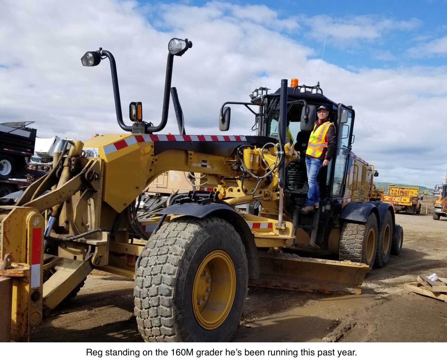 Reg standing on the 160M grader he's been running this past year.