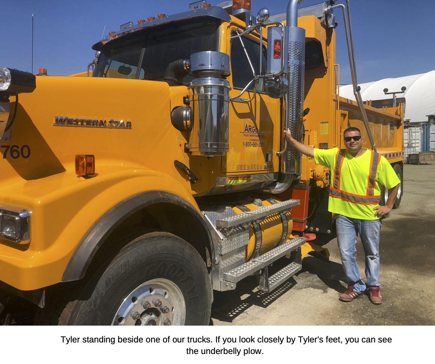 Tyler standing beside one of our trucks. 